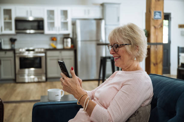 istock Vital senior woman at home, using smart phone for video calling 2161517661