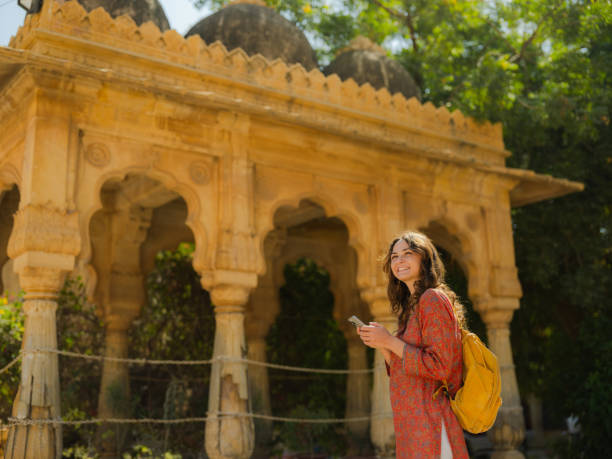 istock Woman using smartphone exploring Rajasthani architecture in Jaisalmer during trip to India 2161518350