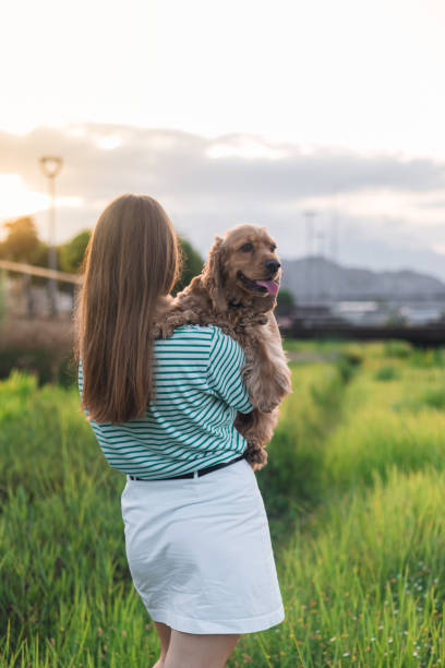 istock Young woman hugs her dog 2161519097