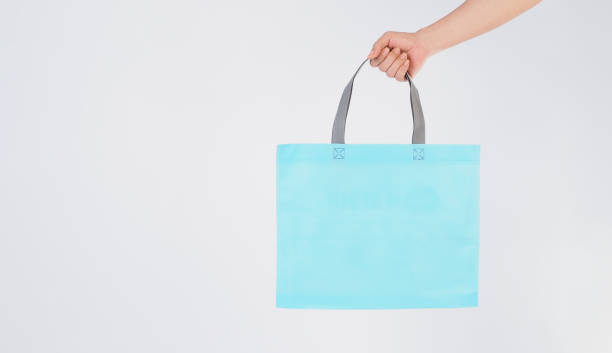 istock Hand is hold light blue Spunbond bag on white background 2161519225