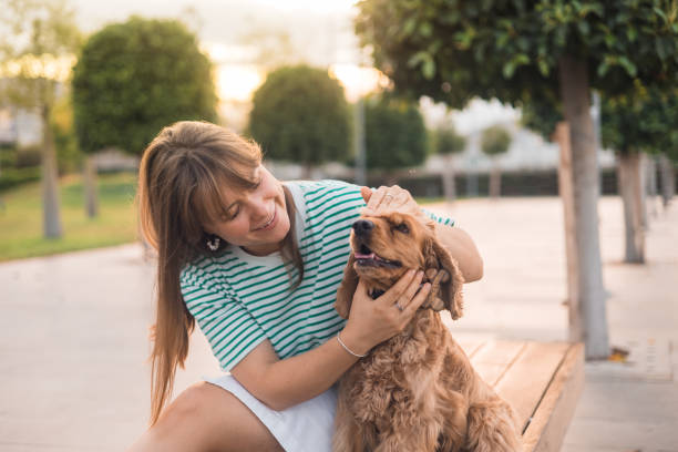 istock Young woman having fun with her dog 2161521254