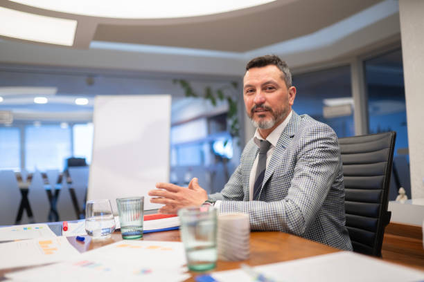 istock Smiling Male Employee in Suit Looking at Camera 2161521500