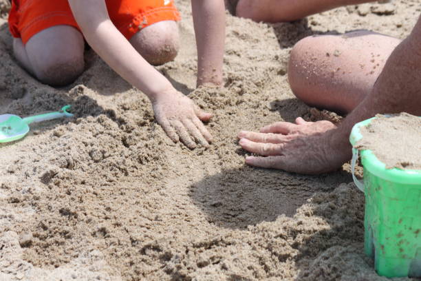 istock Children making a Sand Castle at the Beach 2161521685