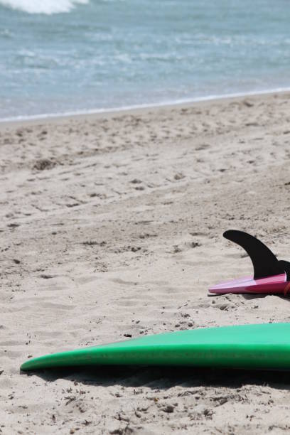 istock Surfboard on the Beach Sand near the Shore 2161521760