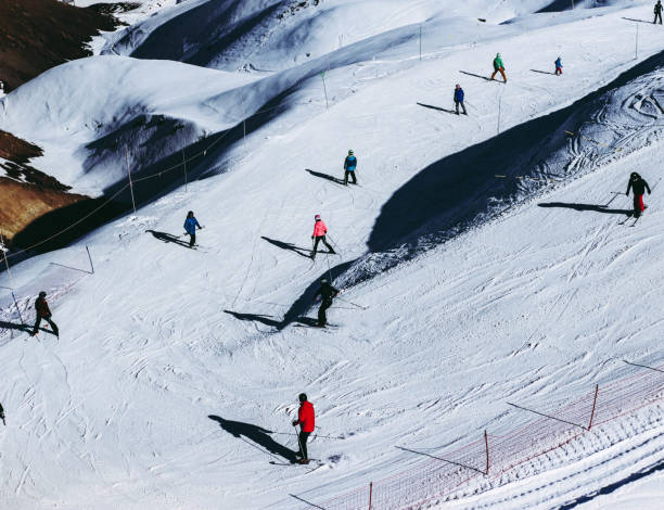 istock Group of people skiing in the snow 2161523609