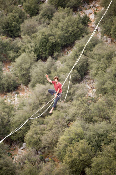 istock A man walks on a tightrope over an abyss. 2161527568