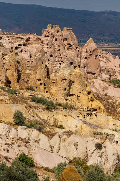 istock he Cappadocian plateau itself is composed largely of volcanic ash, with softer tufa intermixed with harder, more durable igneus rocks like basalt and andesite.  The rocks of Cappadocia near Göreme eroded into hundreds of spectacular pillars and minaret 2161528124
