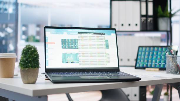 istock Empty office with stock portfolio on devices screens 2161533006