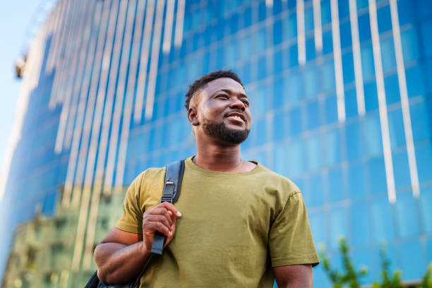 istock Young man walking in the downtown. 2161537254
