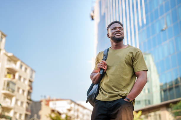 istock Young man walking in the downtown. 2161537271