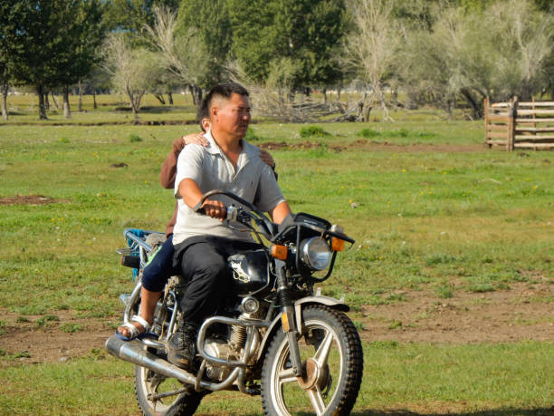 08/25/2016 - Arkangai, Mongolia - A nomad rides his motorcycle on the Mongolian steppe.