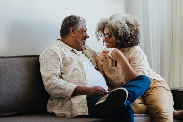 istock Older couple sharing a moment of affection on a sofa 2161540168