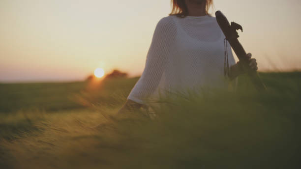 istock Serene Flute Melody by Mature Lady in Wheat Fields at Dusk 2161544917