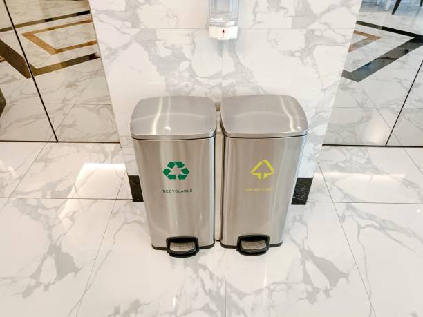 istock Trash can with compartments based on categories for recycling in front of the elevator door 2161551275