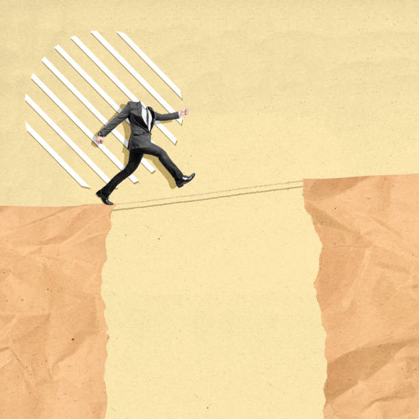 istock Businessman without head walking on a rope over a cliff taking a risky challenge 2161554592