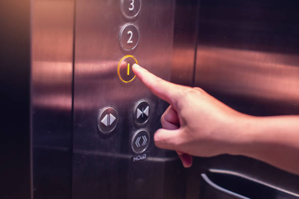 istock Selective focus on forefinger pressing on button in the passenger lift. Close up of elevator control panel in building. Passenger elevator cabin presses floor selection button. 2161554638