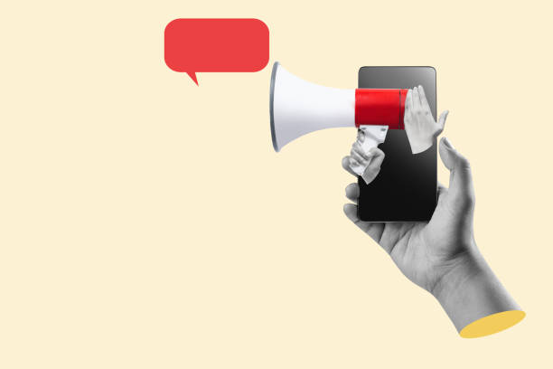 istock A human hand holding the megaphone through a mobile phone screen with an empty speech bubble 2161555649