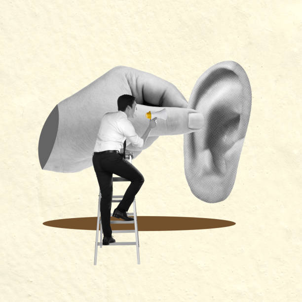 istock Businessman standing on ladder speaking through megaphone to giant ear 2161556565
