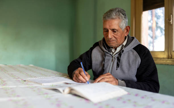 istock Senior man learning to write at home 2161559834