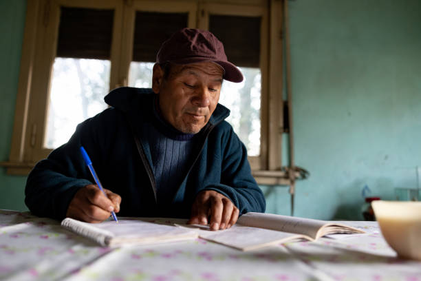 istock Latin American man learning to read at home 2161559858