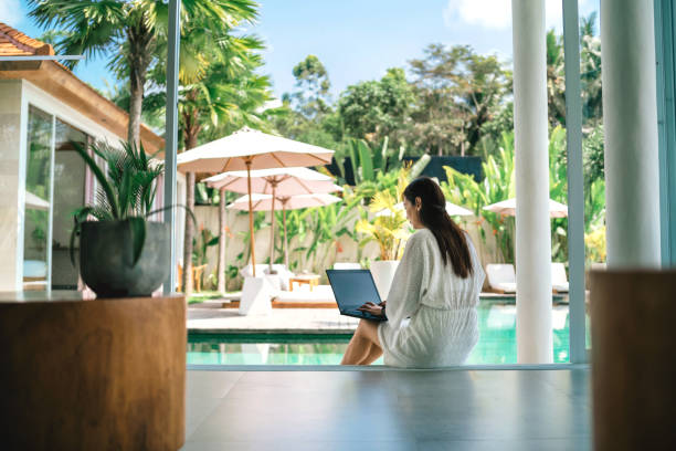 woman working with laptop at poolside
