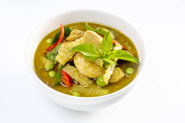 Chicken green curry with coconut shoots isolated on white background.