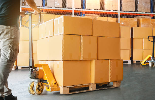istock Workers Loading a Package Boxes in Warehouse. Cartons, Cardboard Boxes. Storage Warehouse. Supply Chain, Supplies Goods Shipment. Warehouse Shipping Logistics. 2161562668