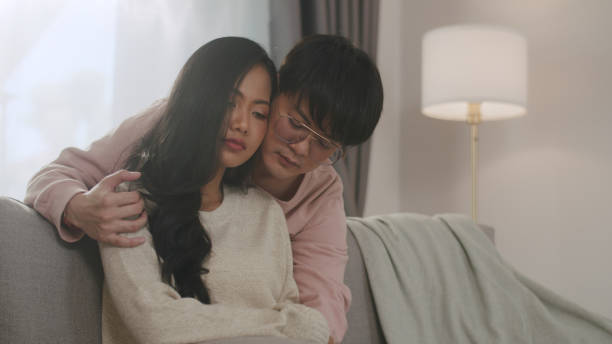 istock Tender Moment Between Young Asian Couple on Couch. 2161567600