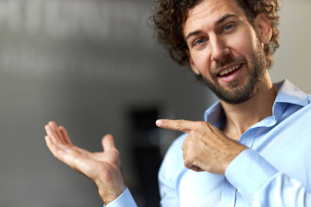 istock Young businessman with an open palm suitable for advertisement. 2161571465