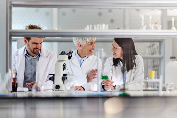 istock Senior scientist and her young colleagues talking in laboratory. 2161571537