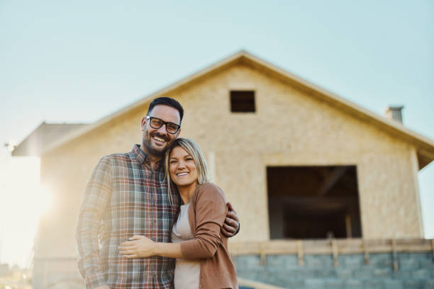 istock Happy couple in front of their developing house. 2161572603