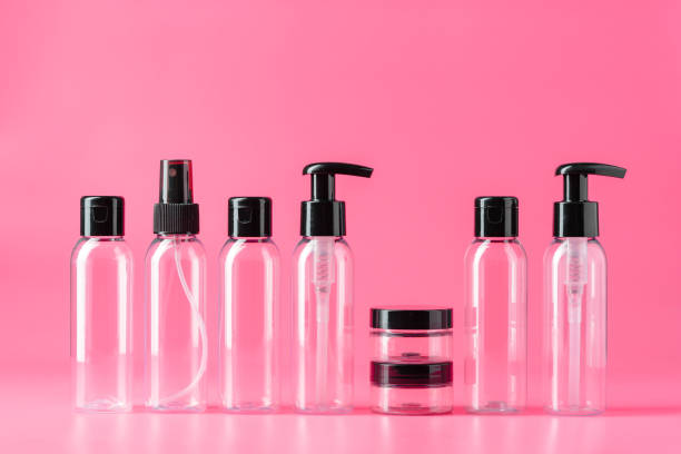 istock Six Clear Plastic Bottles With Black Caps on Pink Background 2161572925
