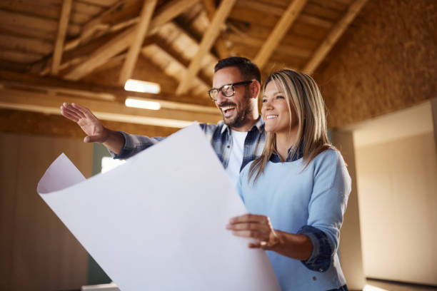 istock Happy couple making plans at their developing house. 2161573173