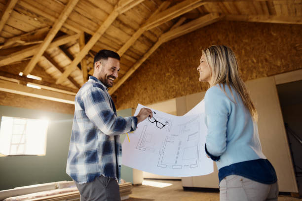 istock Happy couple talking about housing plans at construction site. 2161573469