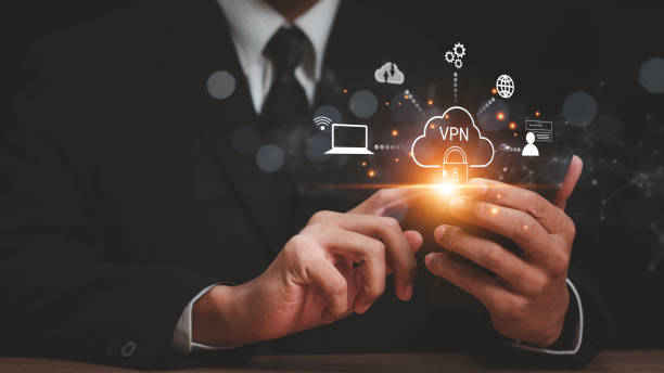 istock VPN Virtual private network concept. Man hand using Smartphone with vpn icon on VR screen. virtual private network channels a secure data connection between your local machine and another VPN server. 2161576573