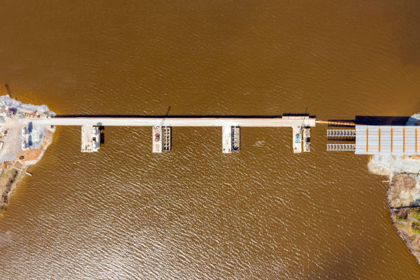 istock Construction of an automobile bridge across the river. View from above 2161576719