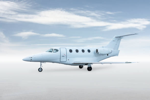 istock Modern white corporate aircraft isolated on bright background with sky 2161580348