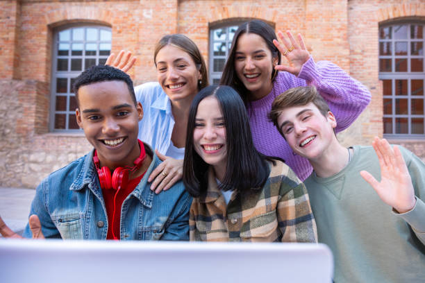 istock Five smiling multiracial friends make a video call on a laptop. 2161583176