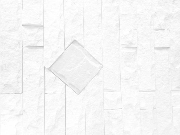 Rough white stone wall background in vintage style for graphic design or wallpaper. Pattern of soft nature floor in retro concept. Gray abstract texture detail in construction or exterior decoration.