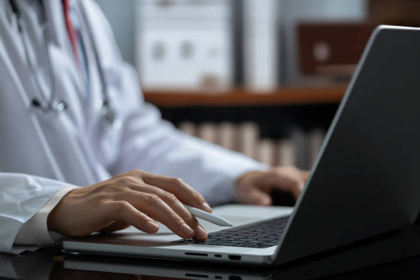 istock Doctor working on a laptop in a luxurious, upscale office 2161585470