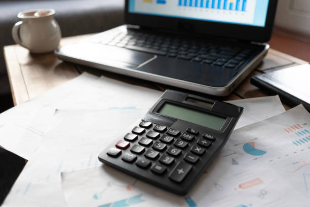 istock financial reports . laptop and calculator on the table at home 2161585829
