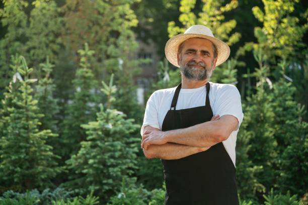 istock Arms crossed, standing. Senior gardener is at work at daytime 2161586852