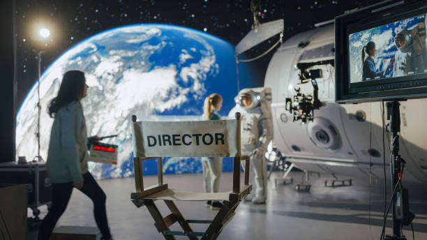 istock Director Filming Astronaut Scene With Digital Earth Backdrop. Actor in Harness Simulates Spacewalk for Ad Shoot. Behind-the-scenes of Virtual Production. 2161588856