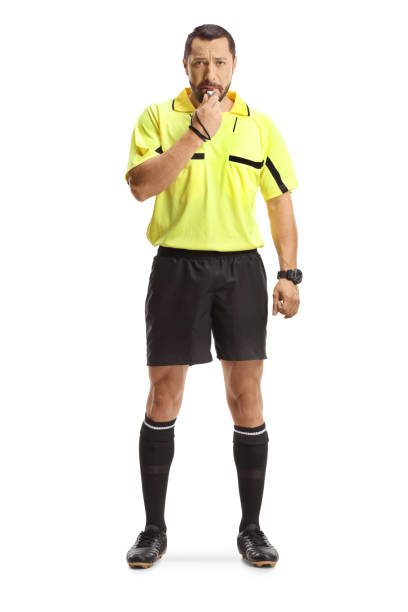 istock Football referee standing and blowing a whistle 2161589531