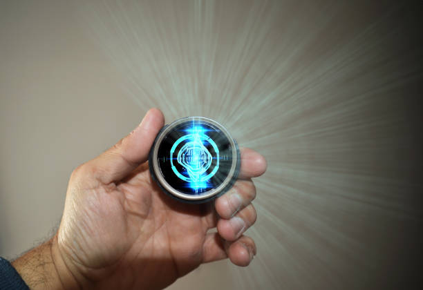 a hand holding a circular quantum cell phone from the future