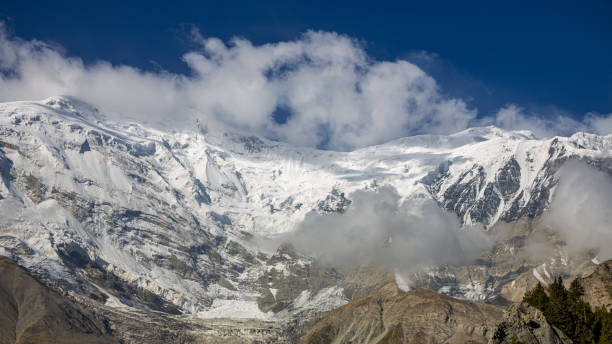 istock Mountains, forests, and snow capped mountains under clear skies 2161594479