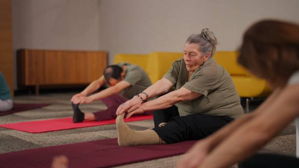 istock Group of multi-racial people practicing yoga together 2161594844