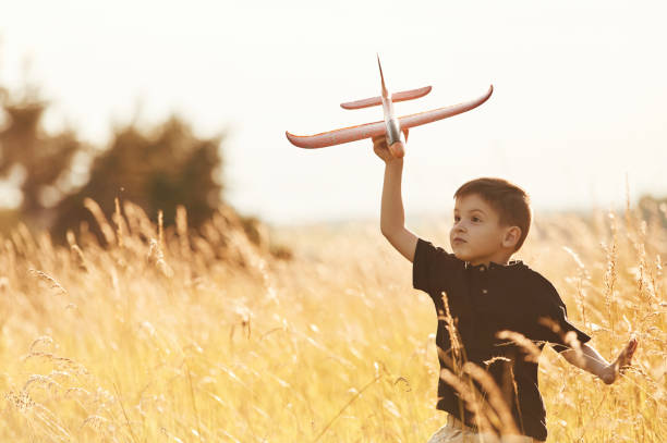 istock Red colored toy plane, playing. Little boy is having fun outdoors at summertime 2161596882