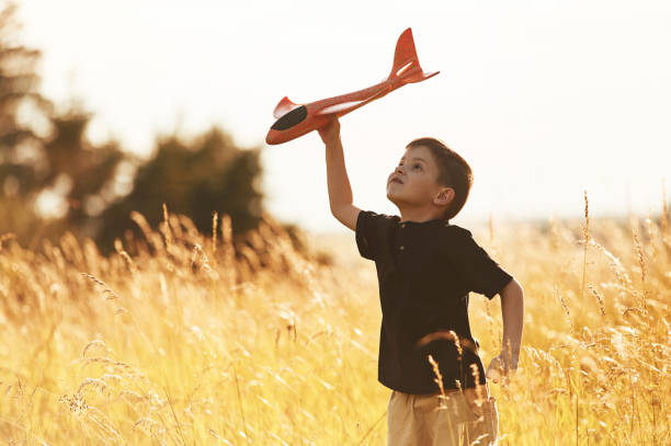 istock Red colored toy plane, playing. Little boy is having fun outdoors at summertime 2161596893