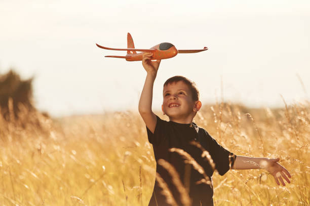 istock Red colored toy plane, playing. Little boy is having fun outdoors at summertime 2161596901